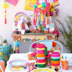 the table is set with colorful decorations and plates