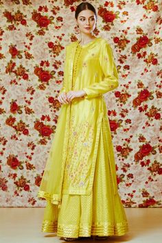 Yellow long kurta with placement floral motif work. Comes with lehenga and dupatta.
Components: 3
Fabric: Silk,Georgette
Neckline: Round
Sleeve Length: Full
Color: Yellow
Embroidered
Straight kurta with side slits
Flared lehenga
Dupatta with lace border and tassel danglings
Closure: Kurta: Front potli loop buttoned placket - Aza Fashions Designer Wear Floor-length Chikankari Embroidery Sets, Designer Chikankari Embroidery Floor-length Set, Yellow Chikankari Embroidery Sharara For Reception, Yellow Chikankari Embroidered Sharara For Reception, Floor-length Sets With Chikankari Embroidery For Festivals, Festive Floor-length Sets With Floral Embroidery, Silk Floor-length Sets With Chikankari Embroidery, Floor-length Floral Embroidery Set For Festivals, Yellow Silk Salwar Kameez With Intricate Embroidery