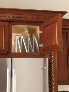 a kitchen with wooden cabinets and stainless steel appliance in the cabinet above it