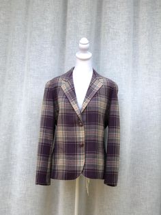 This is a stunning vintage single breasted plaid blazer by Sports Galore in purple/blue colors, two front pockets, two button closure. 100% pure wool. No marked size, please see measurements for proper fit.  Interior has what looks like bleach stains, but overall it's in a good vintage condition!  Measurements ( flat): Shoulder to shoulder: 16" Armpit to armpit: 19" Sleeve Length: 22" Shoulder to Hem: 24" EB8 Single-breasted Plaid Blazer With Lapel Collar, Classic Purple Blazer For Formal Occasions, Tailored Plaid Tweed Jacket With Single Button, Tailored Single-button Plaid Tweed Jacket, Purple Single Breasted Office Blazer, Purple Formal Blazer With Button Closure, Purple Lapel Collar Blazer For Office, Tailored Purple Blazer With Single Button, Plaid Blazer With Suit Collar And Pockets