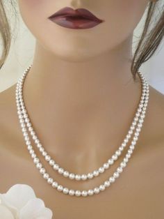 This simple and elegant pearl necklace features 2 graduated strands with pearl sizes from 4mm to 6mm. A sterling silver chain and lobster clasp complete this fine pearl necklace. The perfect finishing touch to your classic or vintage wedding! Elegant Double Strand Pearl Chain Necklace, Elegant Double Strand Pearl Embellished Necklace, Elegant Double Strand Pearl Necklace With Charm, Elegant Double Strand Silver Pearl Necklace, Elegant Silver Double Strand Pearl Necklace, Classic Pearl White Necklace For Mother Of The Bride, Classic Silver Bridal Necklace With Round Beads, Classic White Pearl Necklace For Mother Of The Bride, Classic Pearl Bridal Necklace For Mother Of The Bride