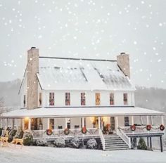 a white house with snow falling on it