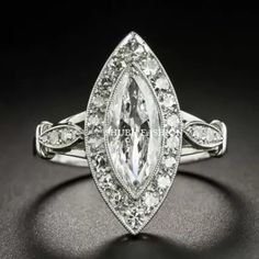 an engagement ring with a large pear shaped diamond surrounded by smaller round brilliant cut diamonds