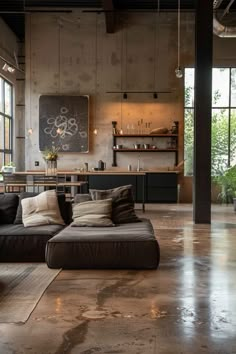 a living room filled with furniture and lots of windows next to a kitchen counter top