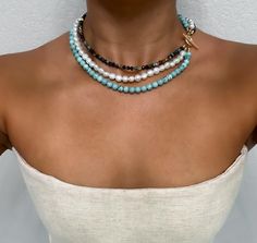 This Pearl Toggle Necklace features a stunning combination of turquoise freshwater pearls and African Turquoise Gem Stones, beautifully arranged in a three-layer design. Crafted from 14k gold-filled materials, this statement jewelry piece adds a touch of elegance and sophistication to any outfit. Its toggle clasp not only enhances its chic appeal but also makes it easy to wear. Perfect for both everyday looks and special occasions, this necklace is a must-have for any jewelry collection. 𝐄𝐋𝐄𝐆𝐀𝐍𝐂𝐄: The color palette of this necklace adds a touch of serenity and natural charm, creating an ambiance of grace and sophistication 𝟏𝟒𝐊 𝐆𝐎𝐋𝐃 𝐅𝐈𝐋𝐋𝐄𝐃 𝐂𝐋𝐀𝐒𝐏: This necklace is adorned with a 14k gold-filled clasp, providing a luxurious and timeless finish that complements its in Three Layer Necklace, Semi Precious Necklace, Turquoise Gem, Original Necklace, Contemporary Jewelry Design, Toggle Necklace, African Turquoise, Layer Necklace, Necklace Turquoise