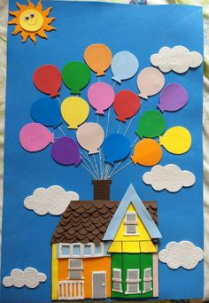 a paper house with balloons floating in the sky