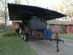 a truck with an awning attached to it parked in front of a house