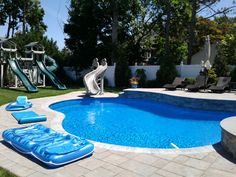 an inflatable pool with slide and water toys