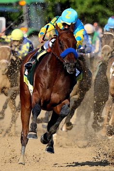 jockeys on horses racing in the dirt