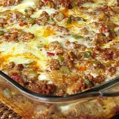 a casserole dish with meat, cheese and vegetables in it sitting on a table