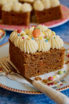 a slice of carrot cake on a plate with a fork