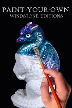 a person holding a paintbrush in front of a blue and white dragon statue with the words paint - your - own windstone editions centrepieces written on it