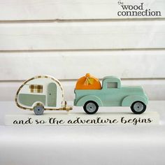 a small toy truck with an orange pumpkin in the back and a wooden sign that says, and so the adventure begins