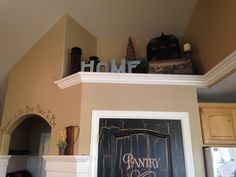 there is a sign above the door that says home on top of a fireplace mantel