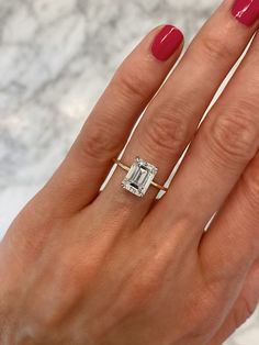 a woman's hand with a ring on it and a diamond in the middle