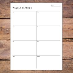 a printable weekly planner is shown on a wooden surface with wood planks in the background