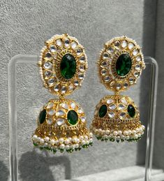 Handmade Style: Traditional Kundan Jhumka Earrings Material: 18k Yellow Gold Plated, Lab Simulated Emerald Stones, Kundan Stones, Pearls Imported Item Number: 7073E Kundan Hand Set Jhumkas For Celebration, Festive Yellow Gold Hand-set Chandbalis, Festive Round Jhumkas With Hand Set Details, Traditional Hand Set Yellow Gold Earrings, Festive Hand Set Round Jhumkas, Festive Yellow Gold Hand Set Danglers, Hand Set Round Jhumkas For Festivals, Bollywood Style Kundan Jhumkas In Yellow Gold, Bollywood Style Hand Set Jhumkas For Festivals