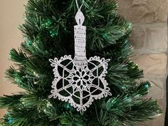 a christmas tree with a snowflake ornament on it