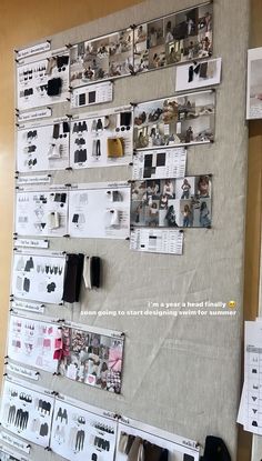 a bulletin board with clothes hanging on it's sides and pictures attached to the wall