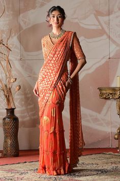 Rust orange banarasi georgette pre-draped sharara saree with circular motifs embroidery. Comes with a banarasi brocade blouse with cutdana hand work. - Aza Fashions Designer Wear Pre-draped Saree With Self Design For Navratri, Festive Orange Pre-draped Saree, Traditional Draped Sets For Festive Occasions, Traditional Draped Festive Sets, Festive Draped Traditional Sets, Festive Traditional Draped Sets, Festive Draped Sets For Festivals, Festive Draped Sets With Zari Work, Fitted Pre-draped Saree With Cutdana For Festivals