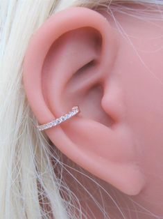 a close up view of a fake ear with a diamond band on top of it