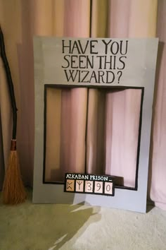 a sign that says have you seen this wizard? with a broom in front of it