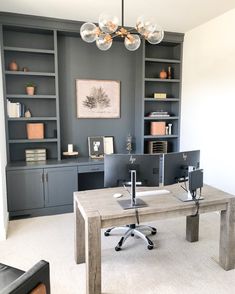 a home office with built - in bookcases and desk