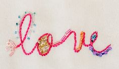 the word love is made with beads and thread