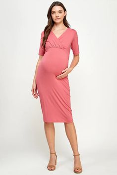 a pregnant woman in a pink dress