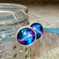 I handmade these galaxy constellation glass earrings using: -Glass cabochons measure 12mm in diameter, and are attached to handmade sealed images, which sit in 12mm sterling silver 925 settings of the lever back earrings -all materials used are Hypoallergenic and lead & nickel free -engraved '925', as they are genuine Sterling Silver Each package contains the pair(s) earrings on a black earring display card which are placed in a small chiffon drawstring pouch ('organza gift bag'), then caref Stars And Galaxy, Galaxy Constellation, Black Earring, Universe Images, Galaxy Jewelry, Galaxy Necklace, Earring Trends, Blue Circle, Galaxies Stars