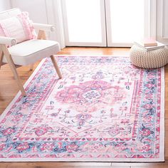 a pink and blue area rug in front of a door with a white chair next to it