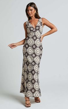 Get ready to turn heads in the stunning Ryhana Midi Dress! This sleeveless slip dress features a deep V neckline and a flattering midi length, making it perfect for any party or special occasion. The striking brown and cream geo pattern adds a touch of elegance to this already glamorous dress. Made from high-quality polyester, this dress is not only stylish but also comfortable to wear all day or night long. Whether you're attending a party during the day or dancing the night away, the Ryhana Mi V-neck Sundress For Cocktail, Fitted V-neck Slip Dress For The Beach, Evening V-neck Sundress Maxi Dress, Evening Sundress With V-neck, Fitted V-neck Sleeveless Dress For Casual Wear, Bohemian V-neck Midi Dress For Night Out, Elegant V-neck Slip Dress For Vacation, V-neck Maxi Dress For Night Out, Bohemian Sleeveless Dress For Night Out