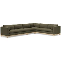 a large sectional couch with wooden legs and dark green fabric upholstered on the back