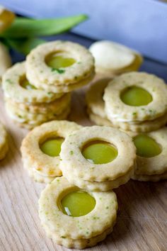 small crackers with olives and cheese on a cutting board