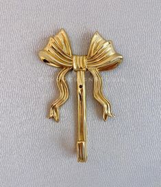 a gold bow tie pin on a white background