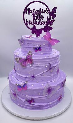 a purple birthday cake with butterflies on it