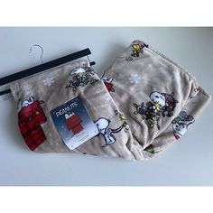 two pieces of cloth with cartoon characters on them, one has a tag attached to it