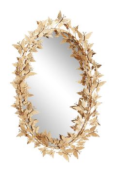 a round mirror with gold leaves on it