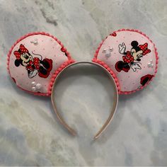 a minnie mouse ears headband on a marble surface