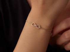 🌟 14K Gold Infinity Bracelet 🌟 Celebrate endless love and connection with our 14K Gold Infinity Bracelet. This elegant piece symbolizes eternity and the unbreakable bonds we cherish. The delicate infinity symbol shines brightly on your wrist, adding a touch of timeless beauty to any outfit. ✨ Available in three stunning colors--classic yellow gold, warm rose gold, and sleek white gold--this bracelet can be customized to reflect your unique style. With lengths ranging from 6 inches to 8.5 inche Sleek Bracelet For Women, Yellow Gold Infinity Bracelets For Everyday, Yellow Gold Infinity Bracelet For Everyday, Dainty Infinity Yellow Gold Bracelets, Dainty Yellow Gold Infinity Bracelet, 14k Gold Infinity Bracelet Gift, 14k Gold Infinity Bracelet For Anniversary, Minimal Gold Bracelet, Infinity Bracelet Gold