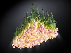 a chandelier with flowers hanging from it