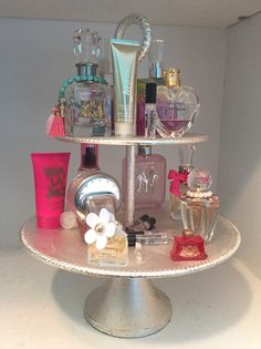 a three tiered display with perfumes and other items