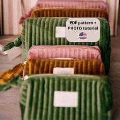 four green and pink cases with tags on them sitting side by side in a row