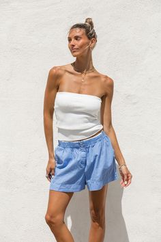 Expertly crafted with a ribbed knit, our High Noon Tube Top offers both comfort and versatility. Its long length provides ample coverage and pairs well with high-waisted bottoms. Perfect by itself or to layer under a breezy button up, this white sweater tube top is a must-have for any wardrobe. Spring Cotton Ribbed Bottoms, Spring Ribbed Cotton Bottoms, Solid Ribbed Bottoms For Summer, Ribbed Stretch Top, Short Length, Ribbed Stretch Short Tops, Ribbed Stretch Short Length Tops, Solid Cotton Ribbed Bottoms, Seamless Bottoms For Spring, Seamless Solid Bottoms For Spring