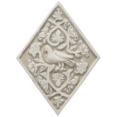 a white tile with a bird on it