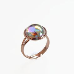 Rose gold is a soft feminine metal that goes with everything. Including this unique bubble-like cabochon which reflects iridescent rainbow shades. The round 12mm stone is made of Swarovski crystal but is not faceted like their typical stones. The smooth round gem fits perfectly into this plated rose gold adjustable ring. Fits approximately size 6 and up. Copyright ©, all rights reserved www.LoveYourBling.com Bubble Ring, Rose Gold Crystal, Soft Feminine, Ring Ring, Adjustable Ring, Adjustable Rings, Swarovski Crystal, Or Rose, Swarovski Crystals