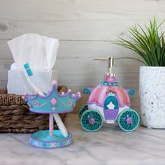 a soap dispenser and toothbrush holder on a counter next to a potted plant