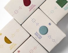 four boxes with different designs on them sitting next to each other in front of a white background