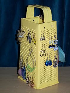 a yellow bag with earrings on it sitting on a table