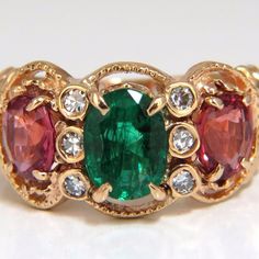 Classic Pinks & Green Three Stone /Mother's Ring. 1.12ct. Natural Emerald 8.2 X 5.6mm Oval Full Cut. Strong, Even Tone. Clean Clarity & Transparent. 1.50ct Natural (2) Spinels. Bright Pink, Clean Clarity & Transparent. .15ct Natural Round Diamonds: G-Color & Vs-2 Clarity. 14kt. Yellow Gold 5.2 Grams Ring Is 11mm Wide. Ring Current Size: 5.75 (Free Resize Service, Please Inquire) $3600 Appraisal Certificate To Accompany. Band Rings Women, Sapphire Halo Ring, Mother's Ring, Turquoise Statement Ring, Ring Three Stone, Blue Diamond Ring, Tanzanite Diamond Ring, Wide Ring, Rings Jewelry Fashion